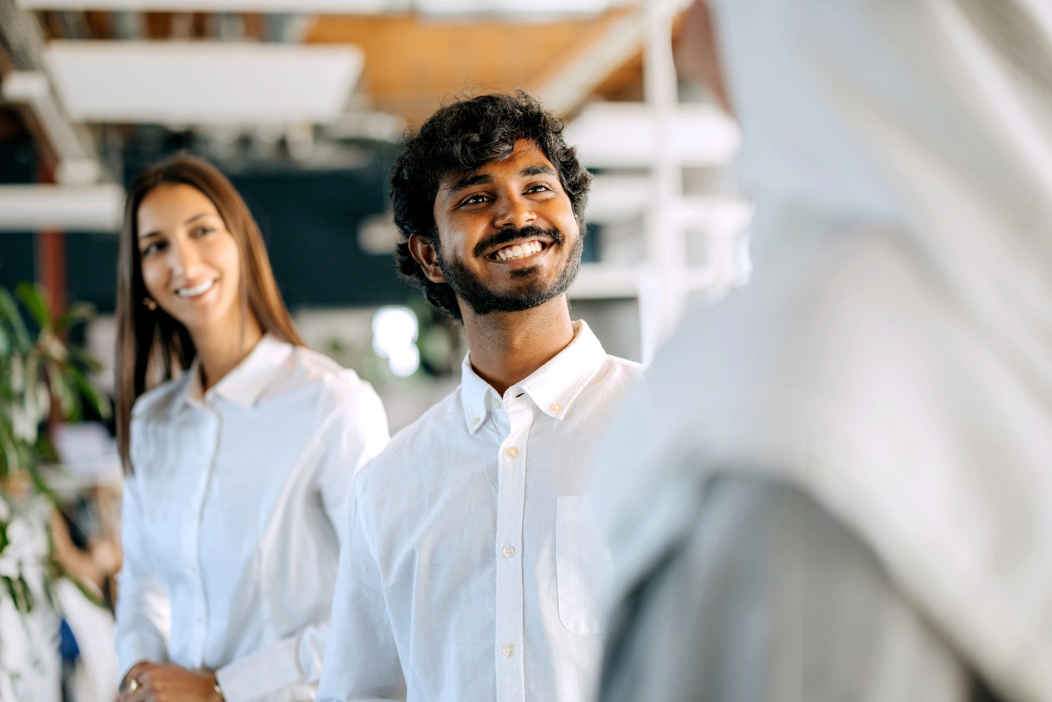 Colleagues talking in a modern office setting