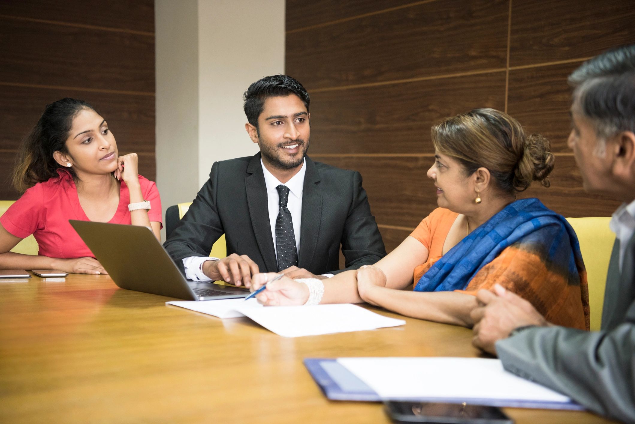 Business colleagues collaborating around a meeting table